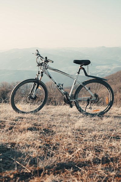 black and white hardtail mountain bike on brown grass field during daytime